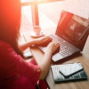 close-up office desk. Workspace with girl's hands, laptop, coffee cup. Business woman. close-up office desk. Workspace with girl's hands, laptop, coffee cup. Business woman.