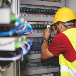 Electrician engineer work tester measuring voltage and current of power electric line in electical cabinet control. Electrician engineer work tester measuring voltage and current of power electric line in electical cabinet control.