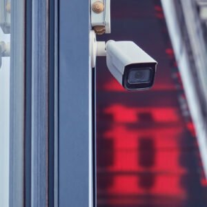 Video surveillance camera on the store building, monitoring the security of the entrance to the shopping center Video surveillance camera on the store building, monitoring the security of the entrance to the shopping center