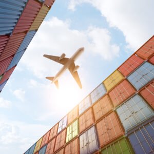 Cargo plane flying above stack of containers at container port Cargo plane flying above stack of containers at container port