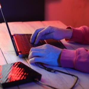 laptop with attached optical drive on the table in front of a person laptop with attached optical drive on the table in front of a person