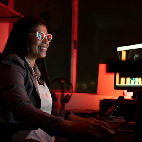 young businesswoman using a computer during a late night at work young businesswoman using a computer during a late night at work